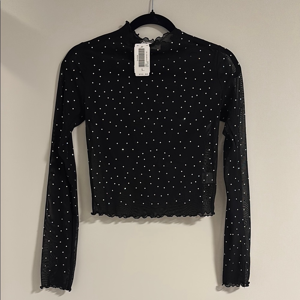 Bejeweled black mesh top with ruffle hem